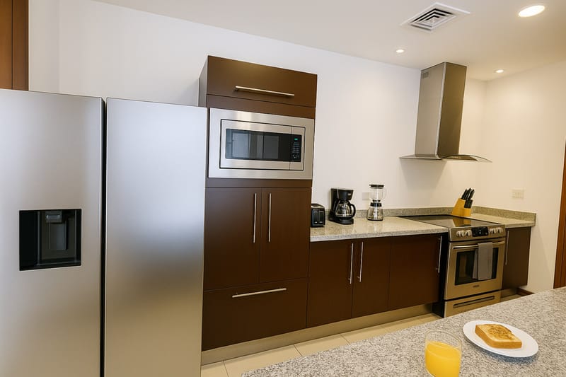 Kitchen with dark cabinets, oven, microwave and granite counters