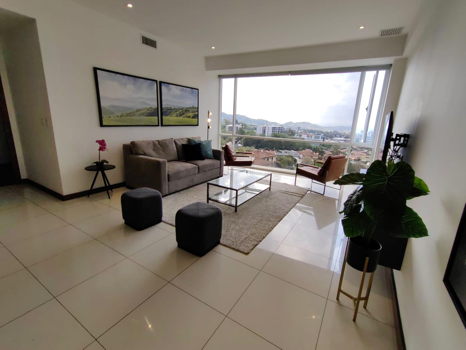 Living room with sofa and armchairs before the view