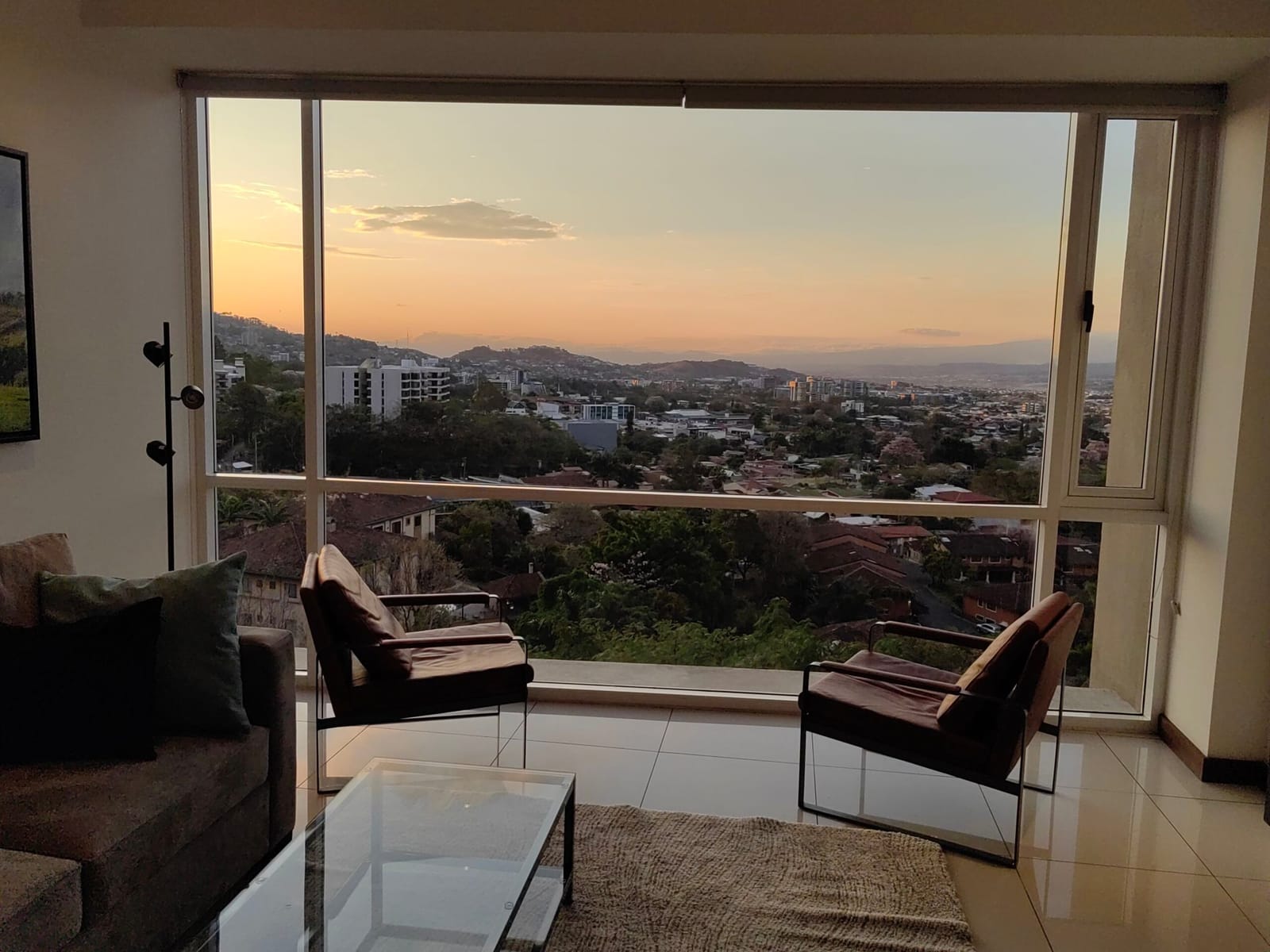 Sunset over the rooftops from the leather armchairs