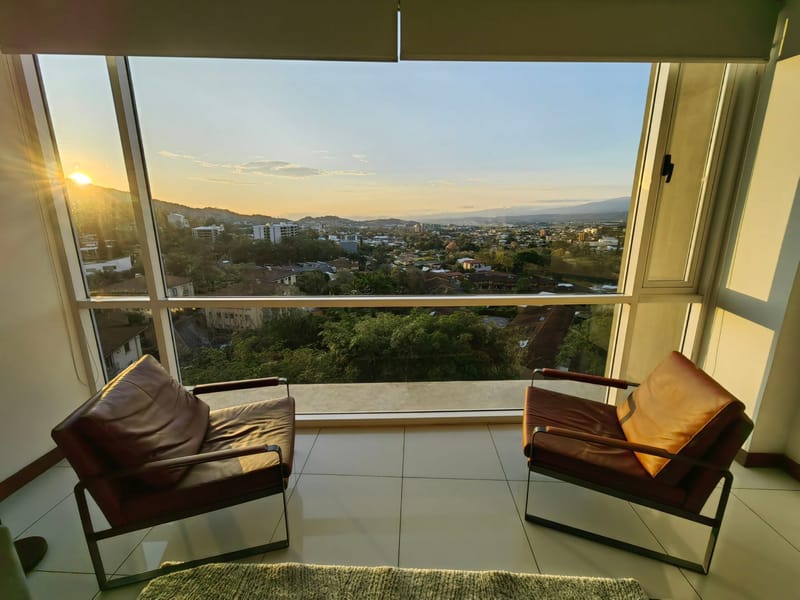 Golden evening light through the window over Escazú