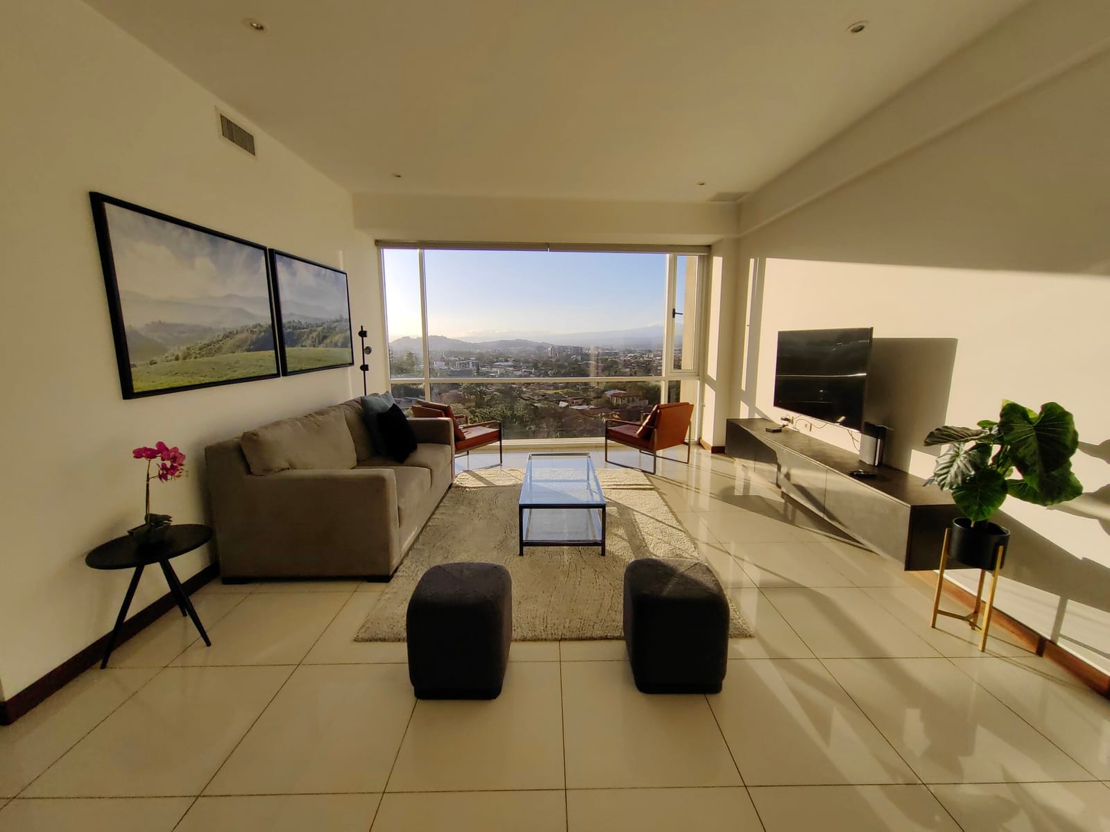 Living room with prints, TV and evening window