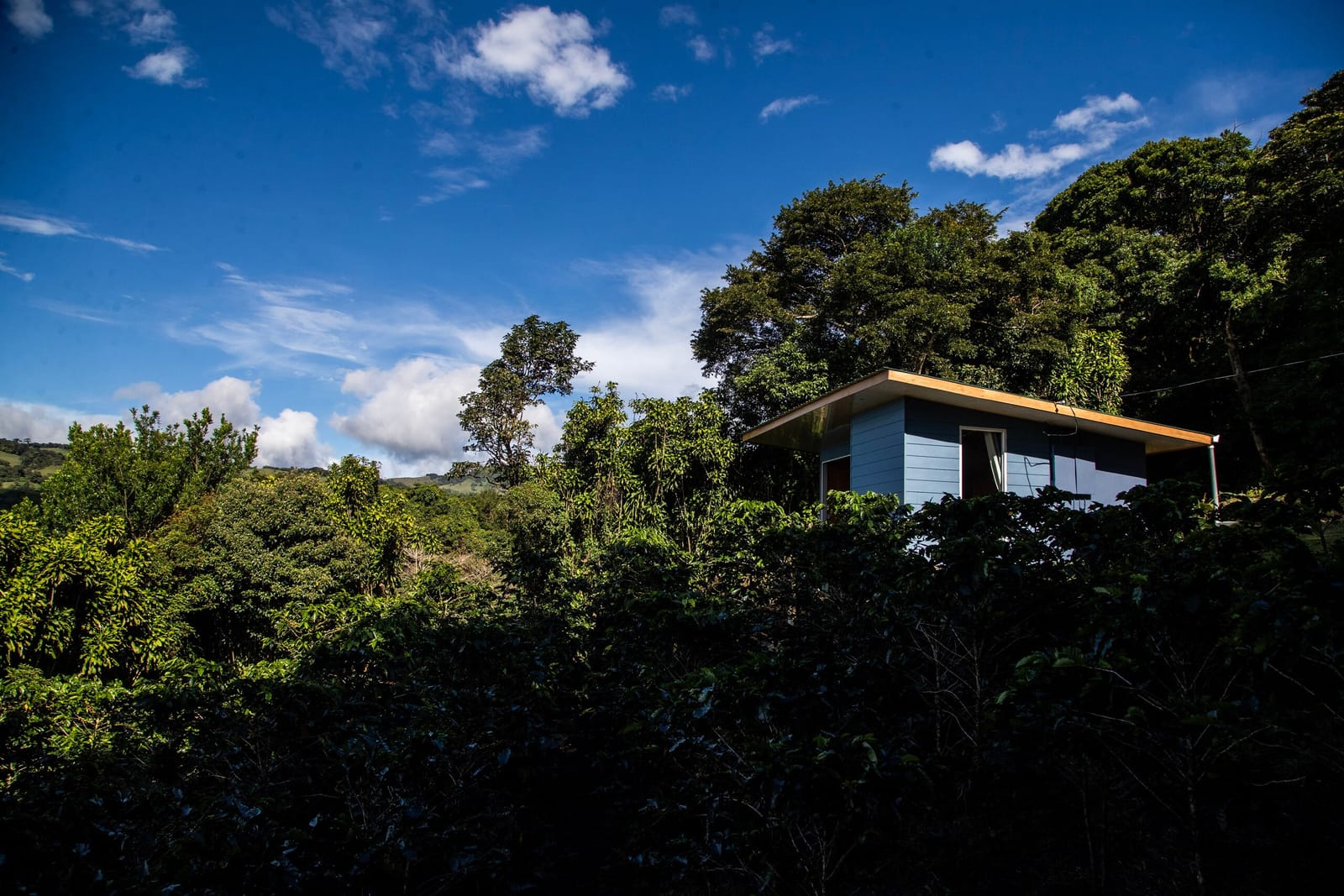 Cabin on the ridge under a blue sky with clouds