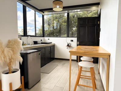 Kitchenette with mini fridge, high table and stool