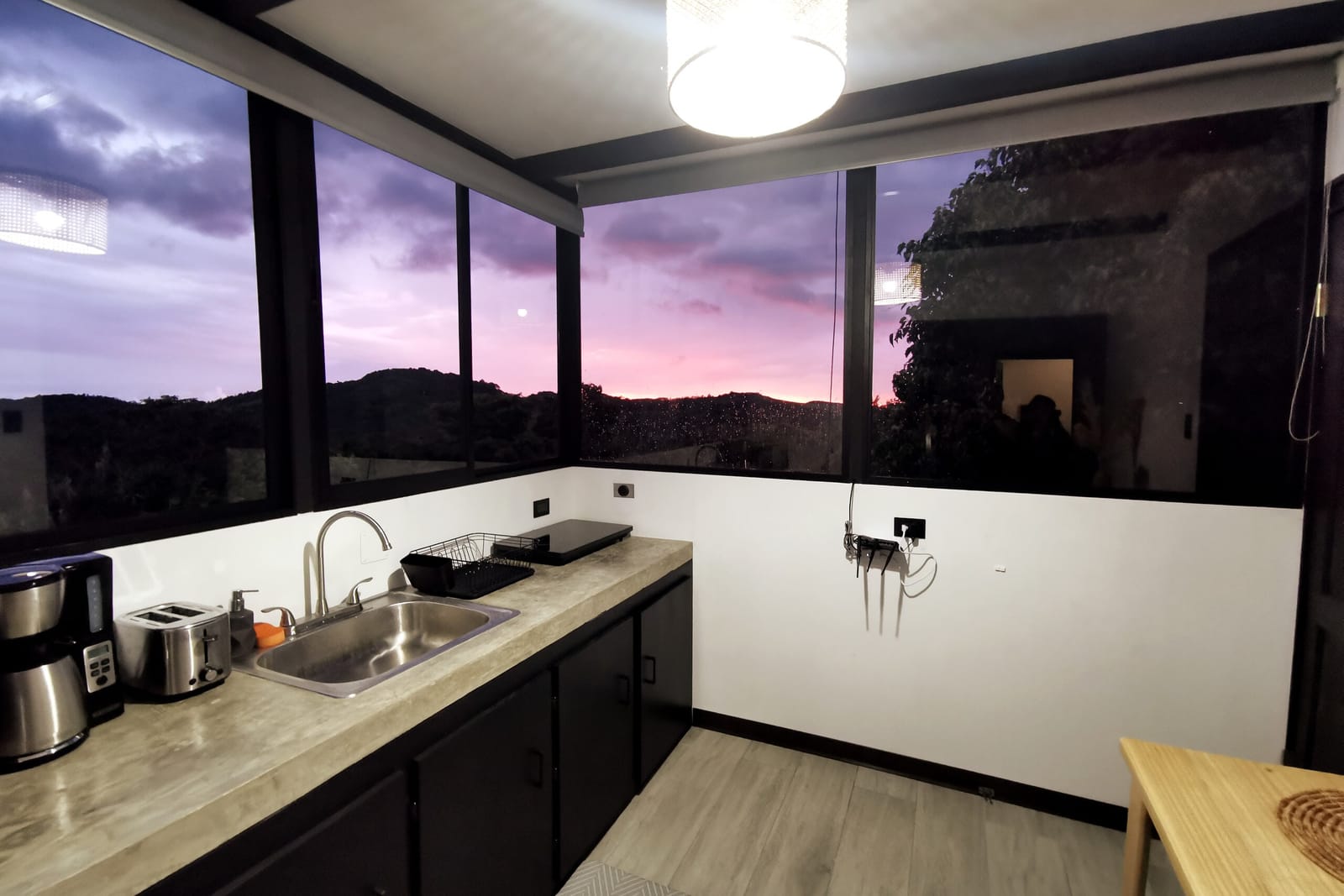 Purple sunset sky over the hills through the kitchen window