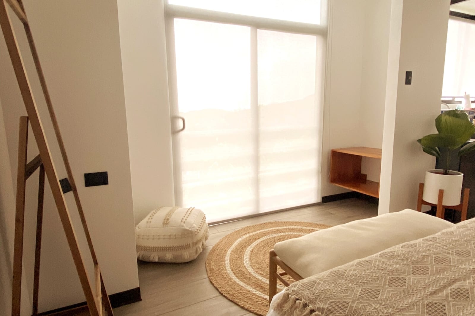 Sliding door with sheer curtain, bench and rug