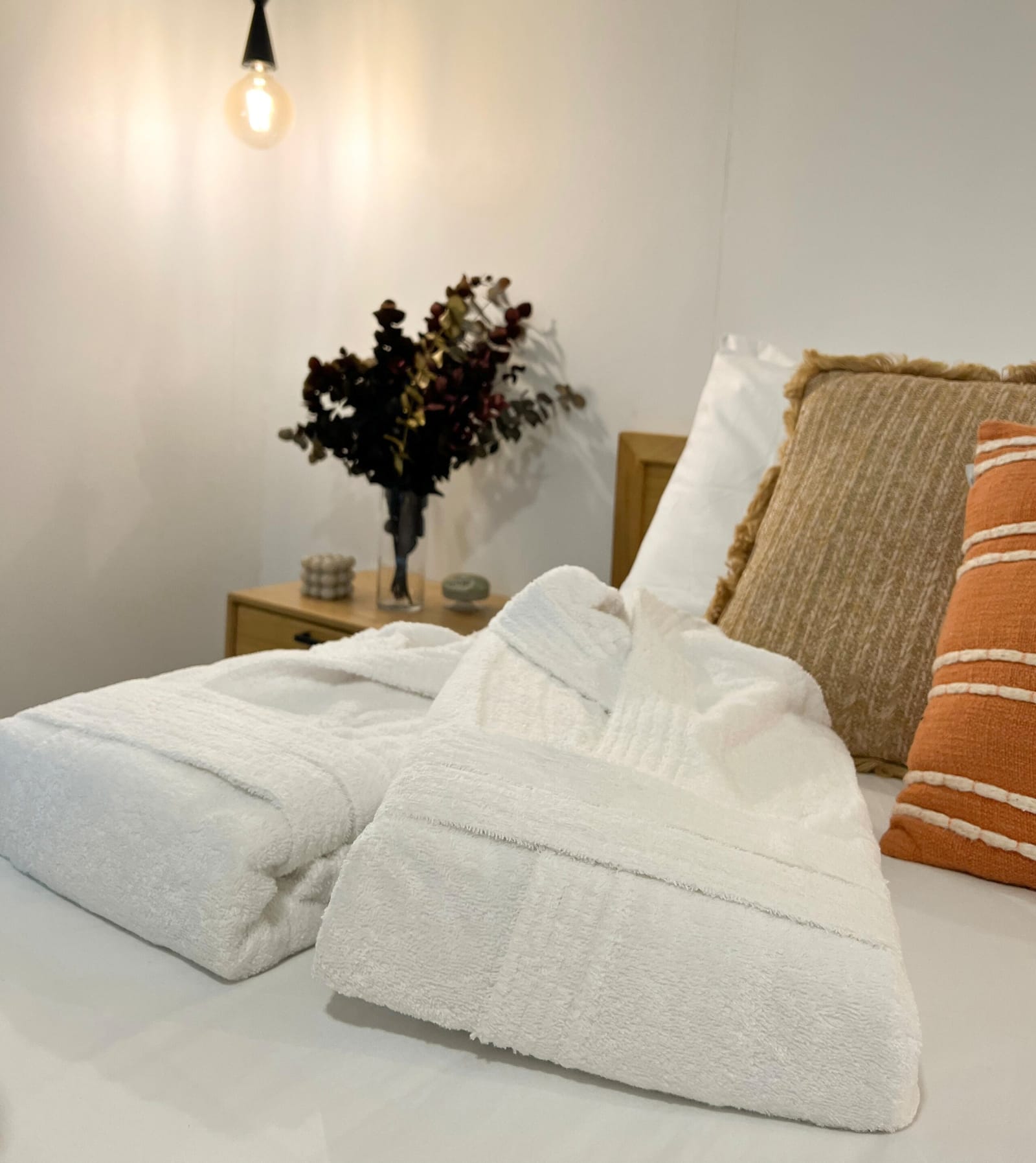 Pillows and folded towels on the queen bed