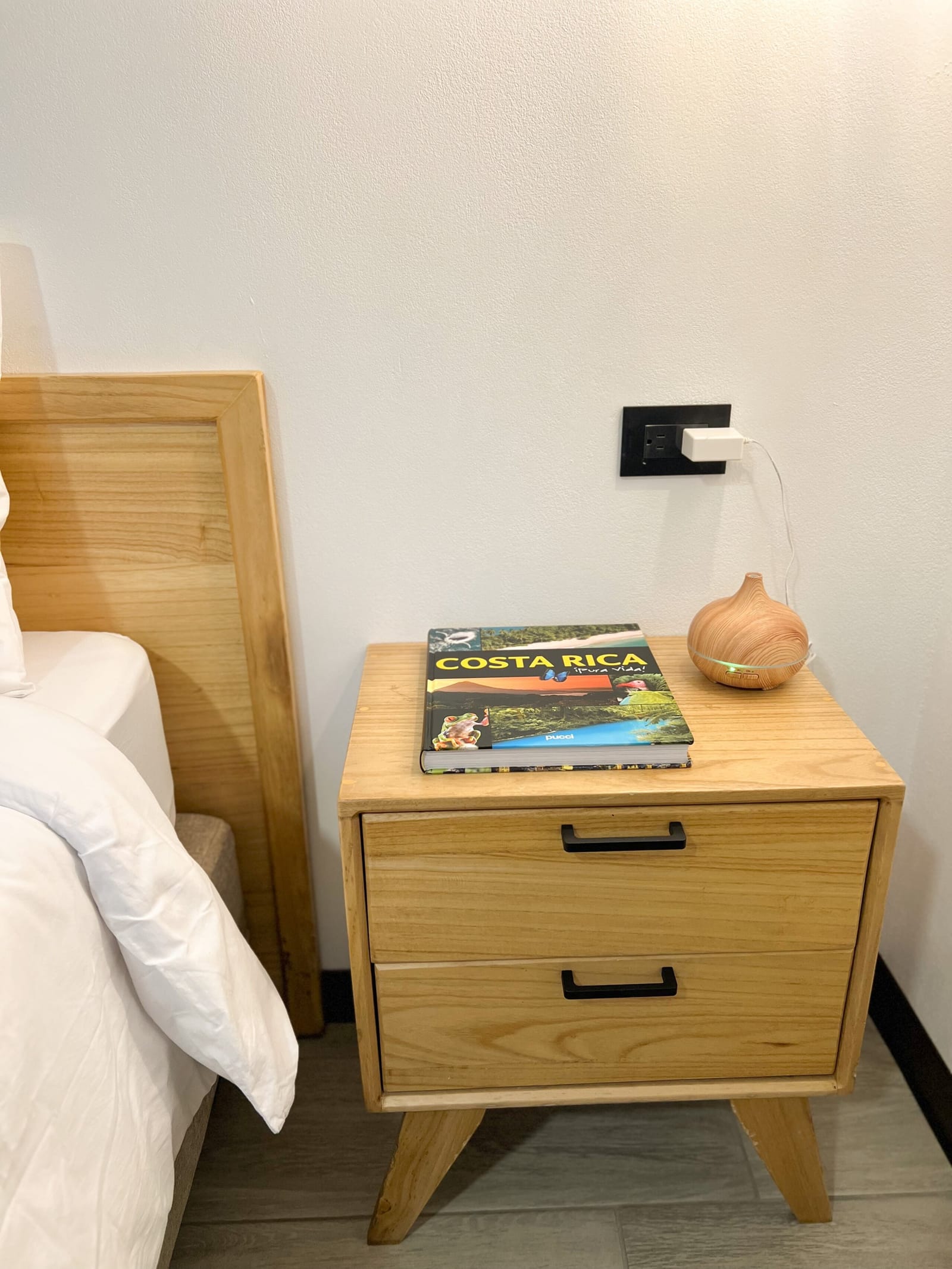 Costa Rica guidebook on the wooden bedside drawers