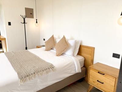Queen bed with coat stand and bedside drawers