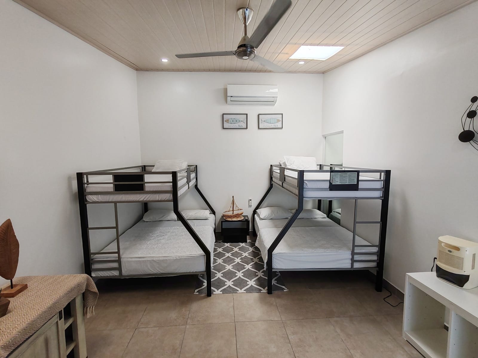 Bunk room with two metal bunk beds and ceiling fan