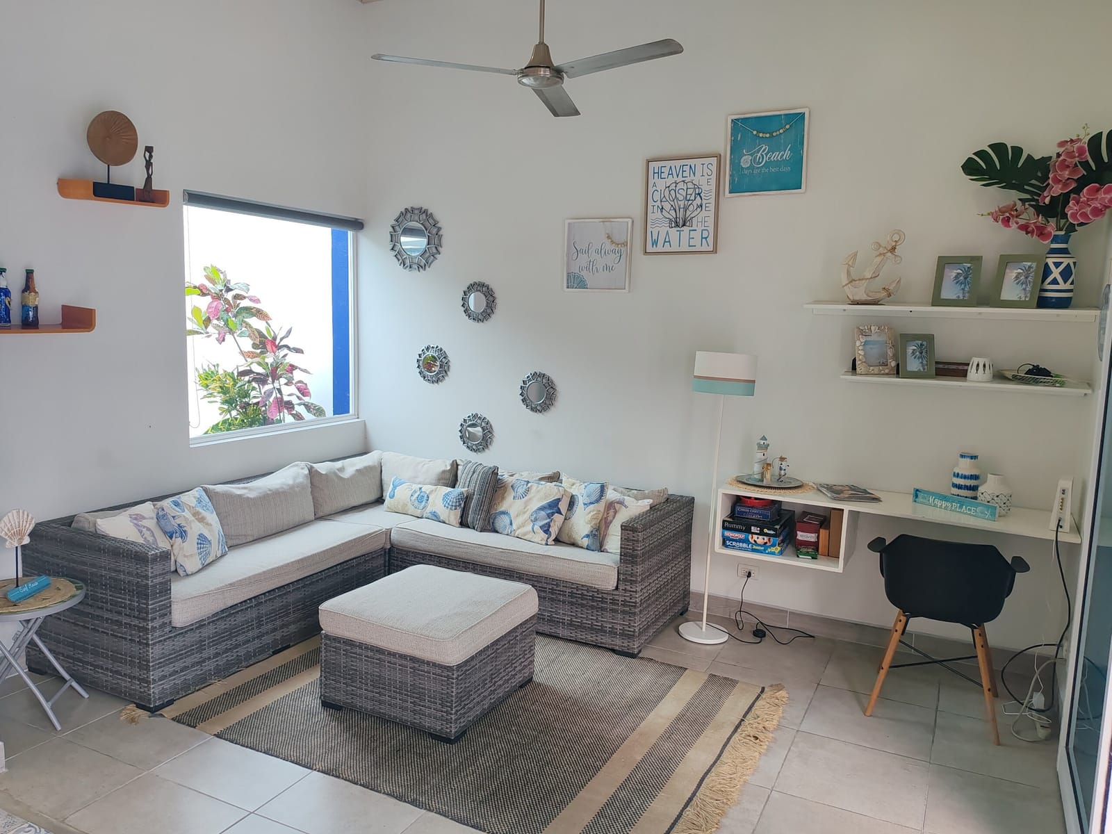Living room with gray sectional sofa and coastal decorations
