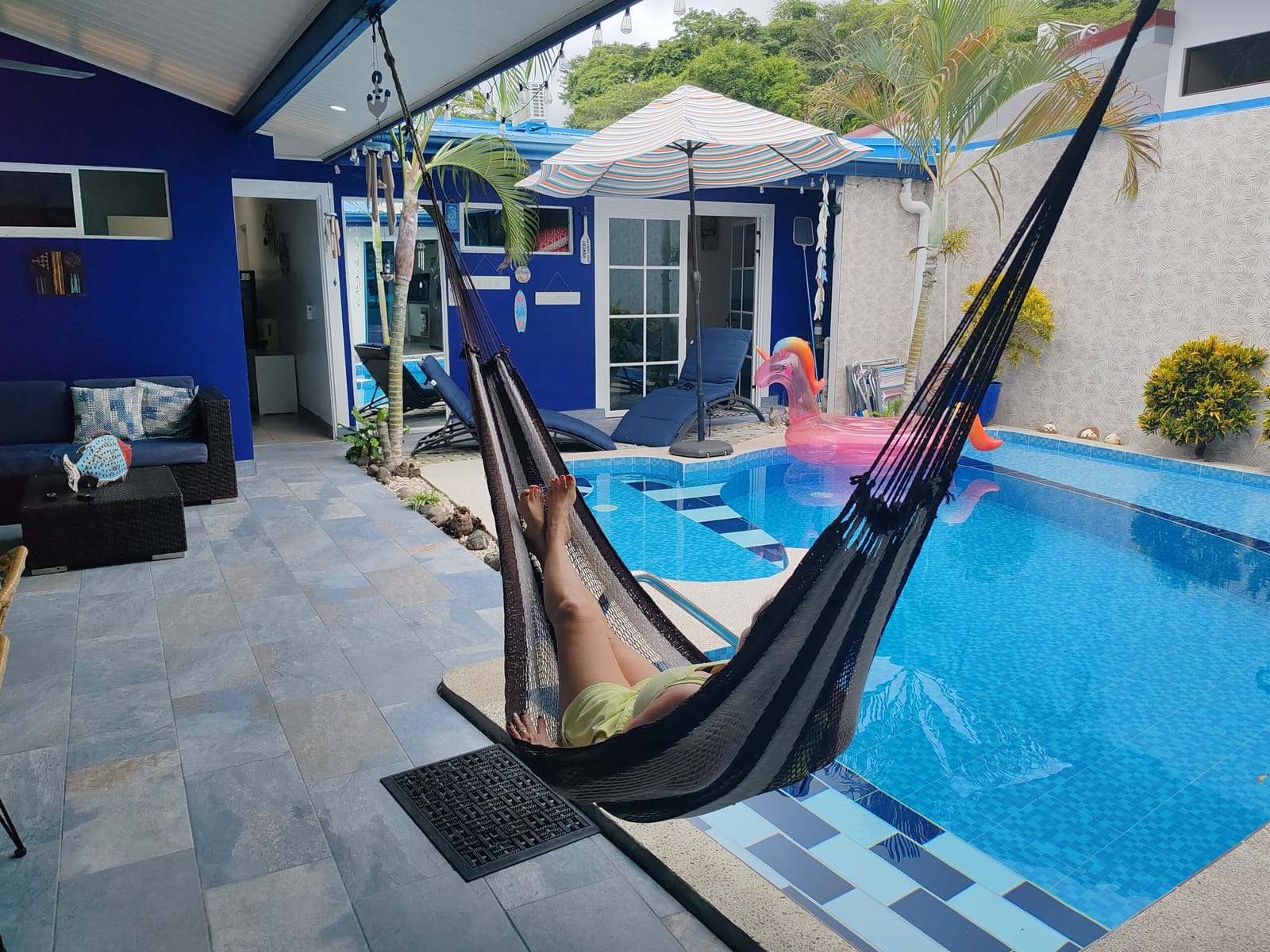 Hammock hanging beside the pool with flamingo float