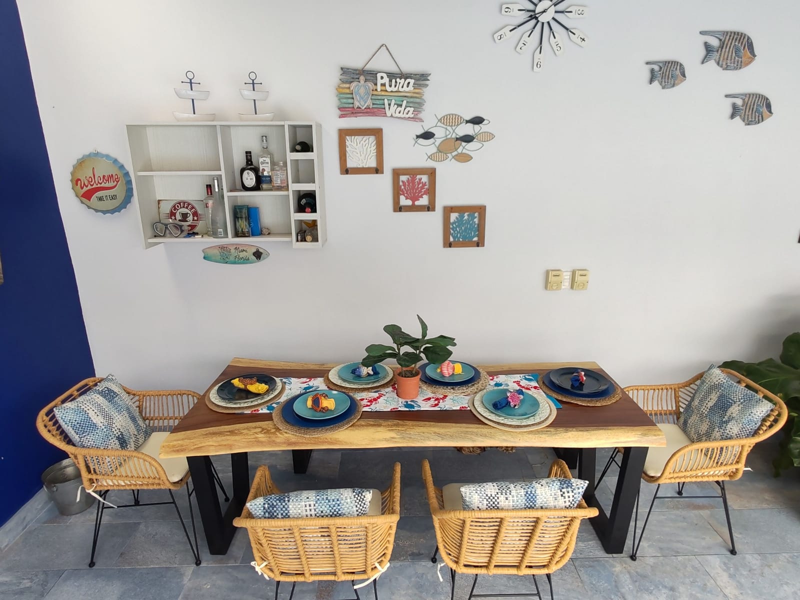 Dining table for six under fish and starfish decor