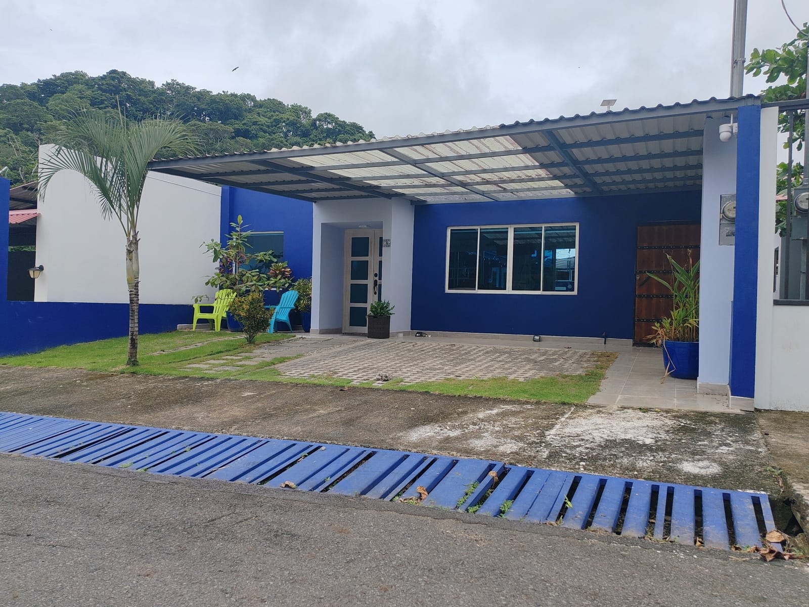 Blue house and carport seen from the street