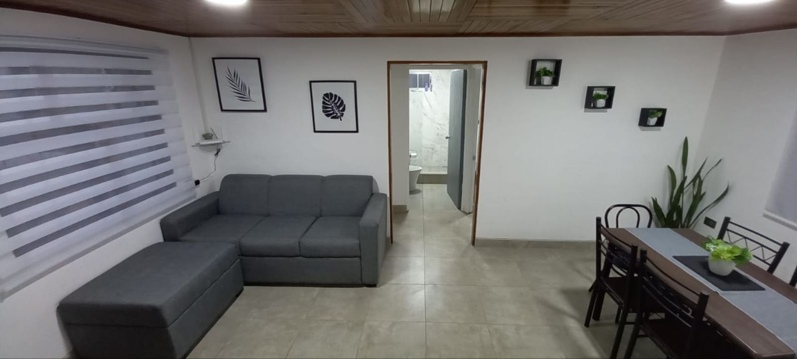 Living room looking through to the bedroom and bathroom doors