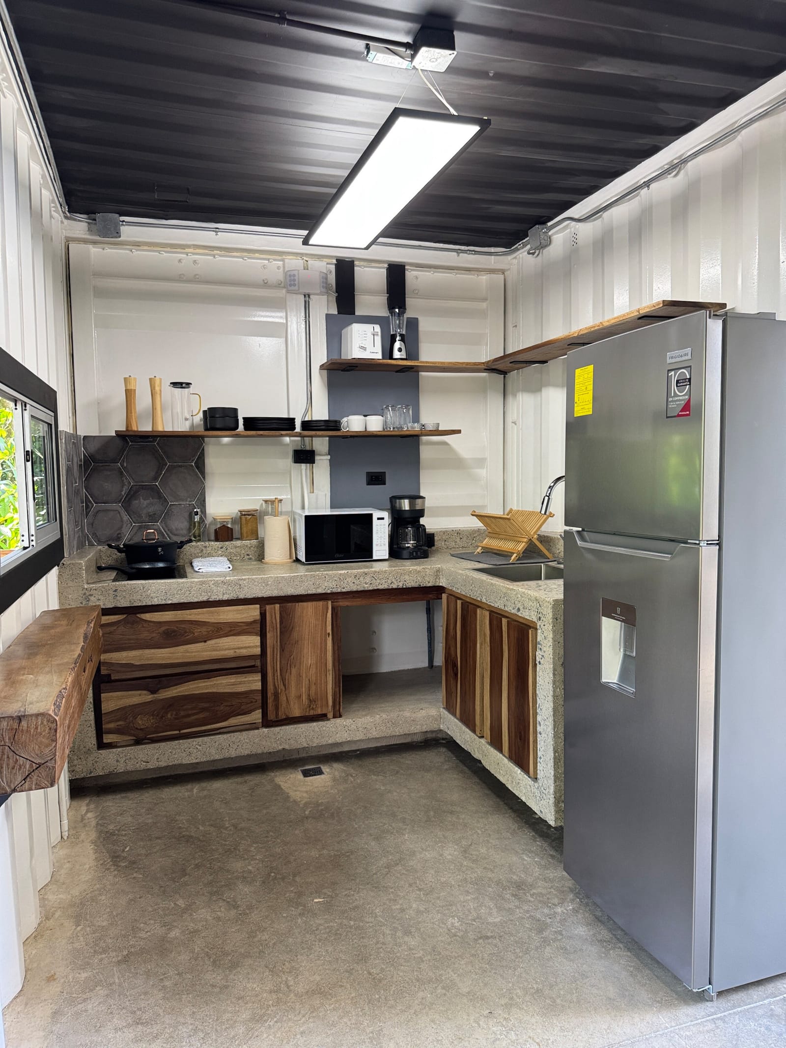 Stainless refrigerator and kitchenette counter under the skylight