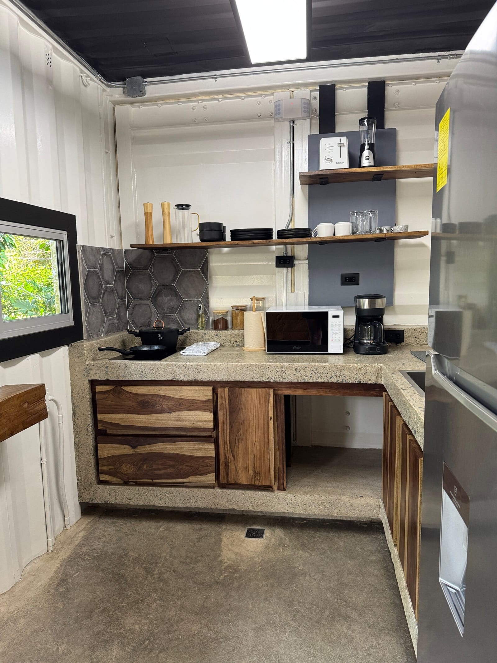 Kitchenette with window over the counter and shelves
