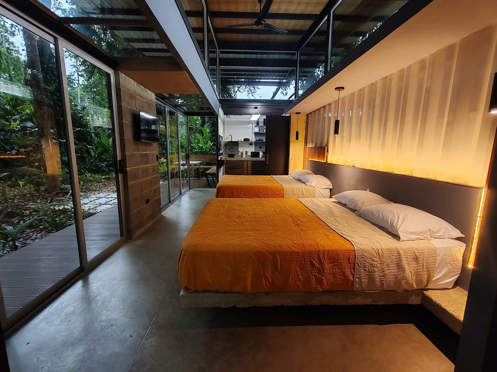 Beds facing the glass wall and the jungle deck