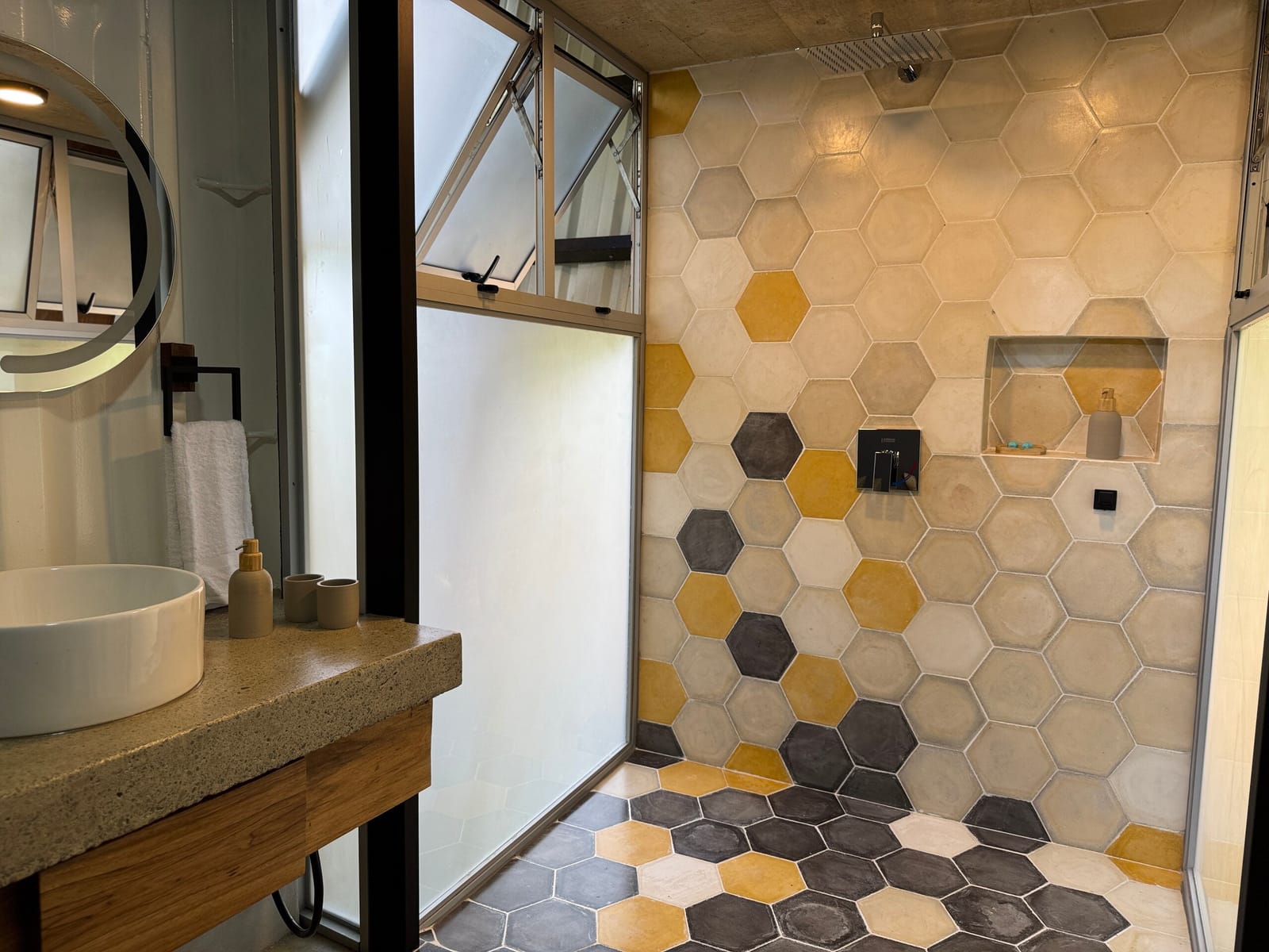 Yellow and gray hexagon tiles in the shower with window
