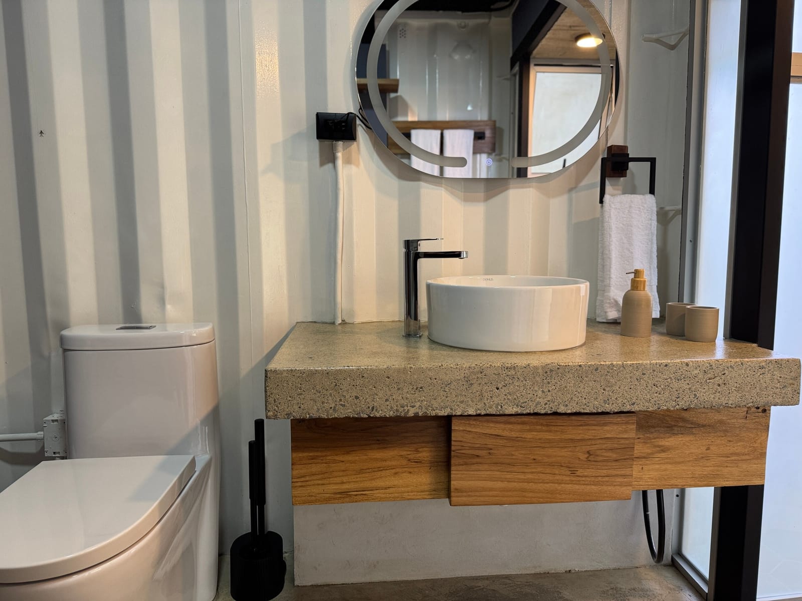 Bathroom vanity with round mirror and wooden drawer