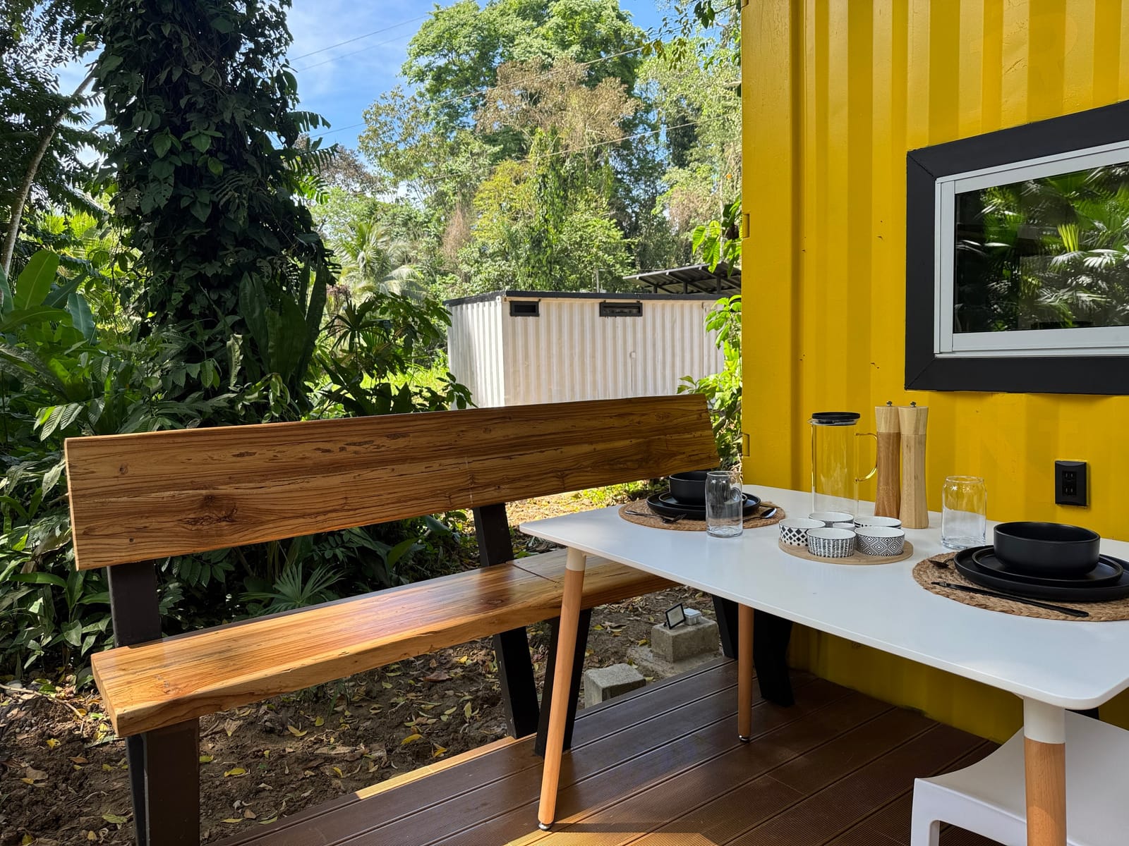 Wooden bench and dining table on the deck at the forest edge