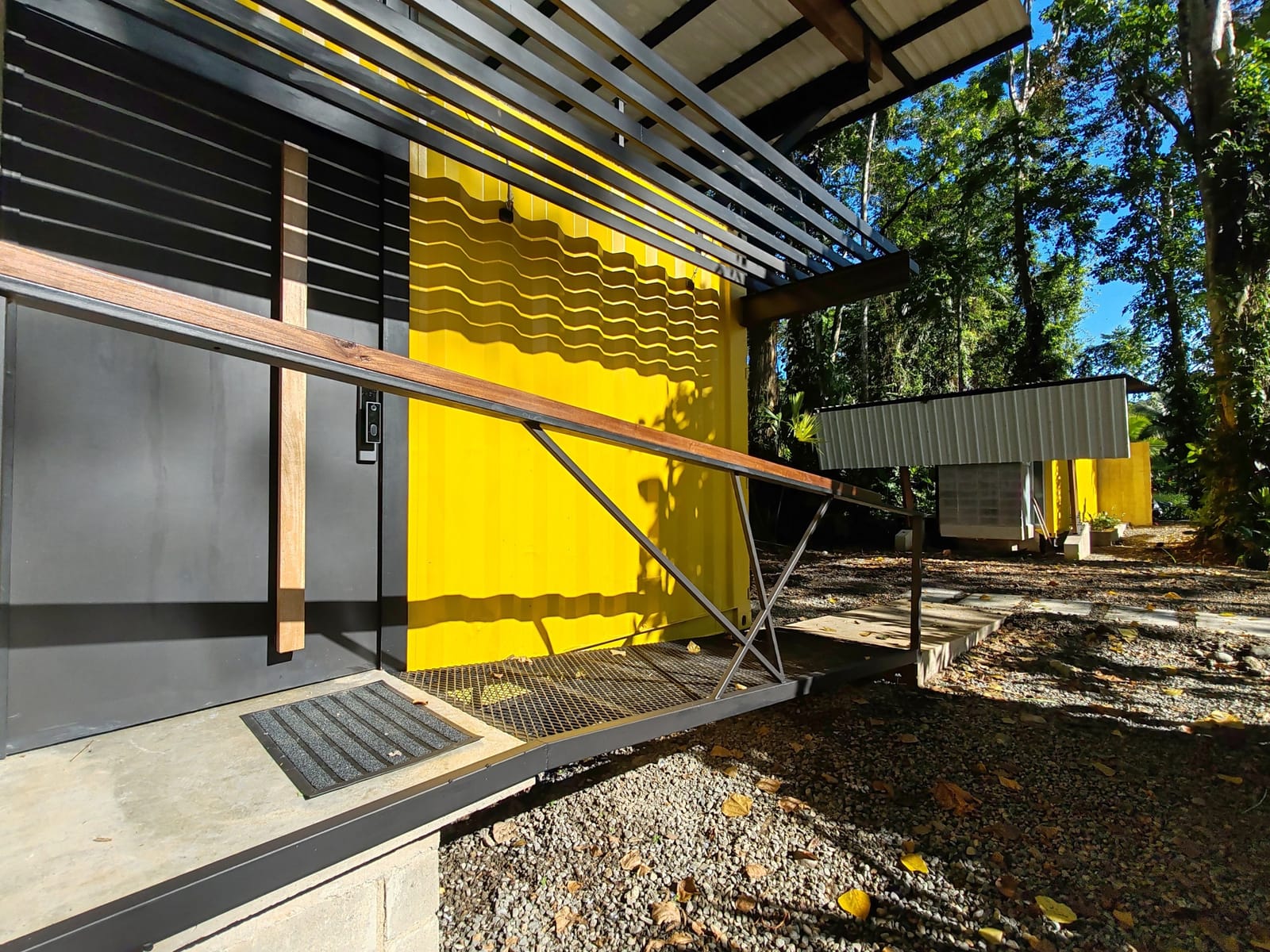 Container entrance with mat under the steel canopy