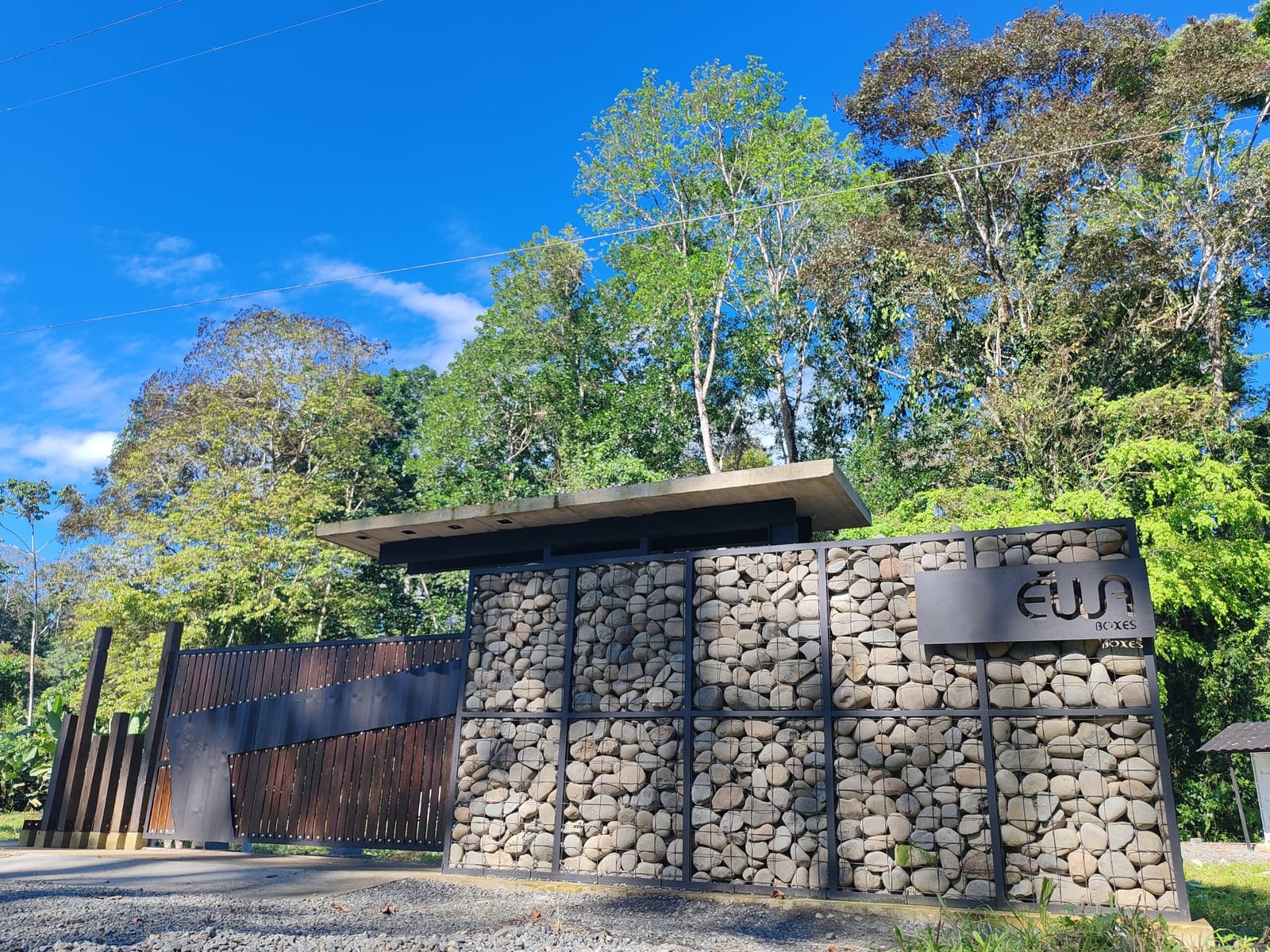 Gabion stone entrance walls with the property sign