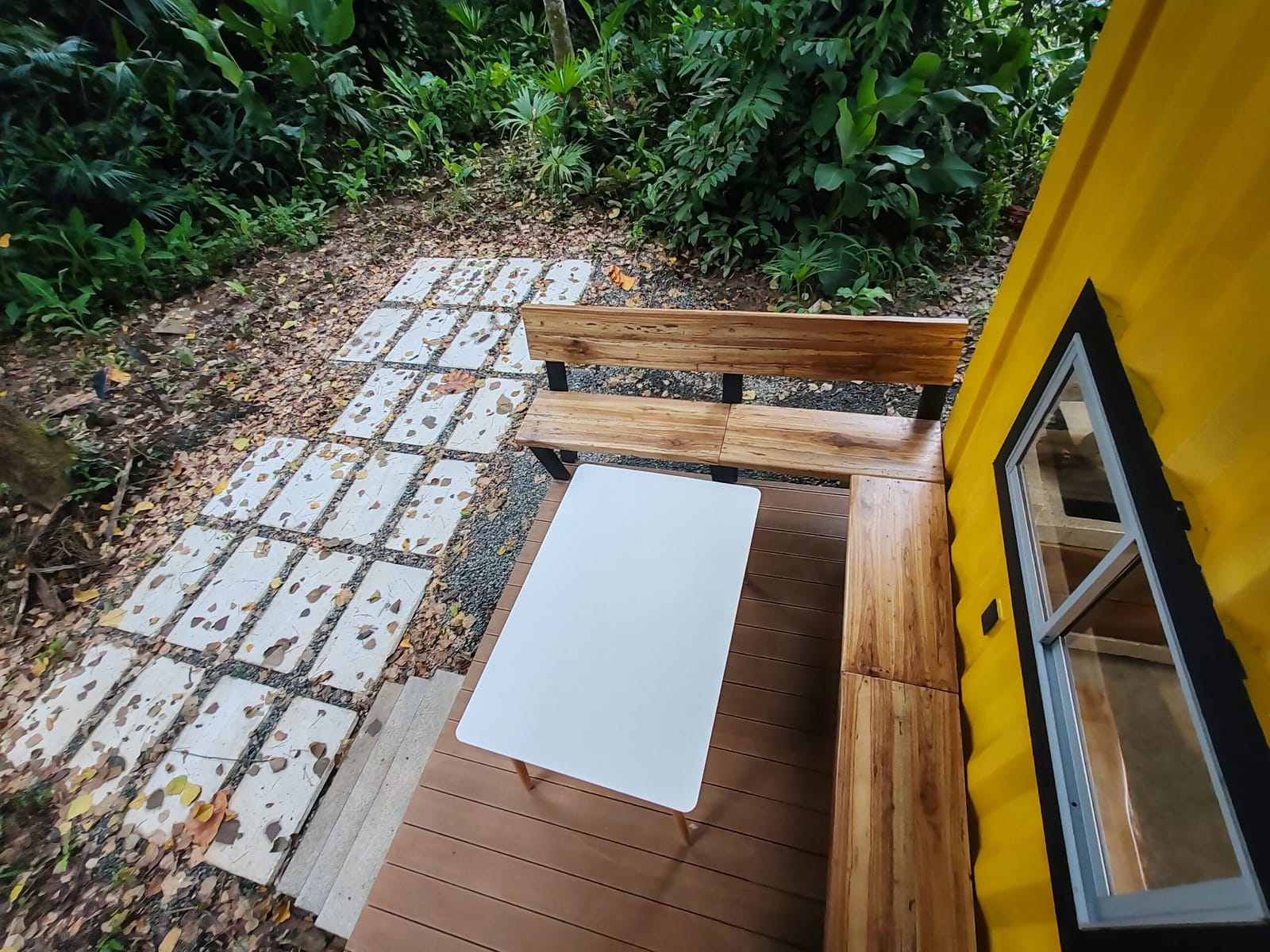 Stepping stones through the leaves to the deck bench
