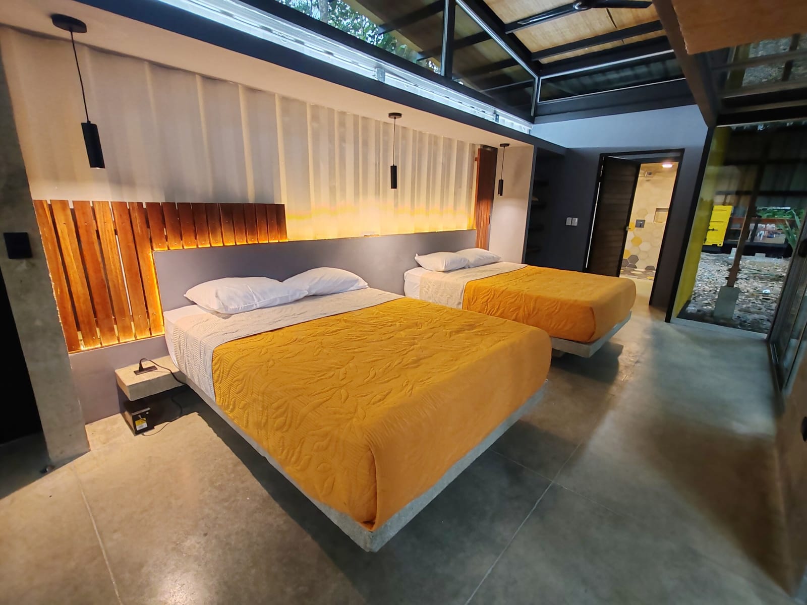 Twin queen beds in the container with the door to the deck