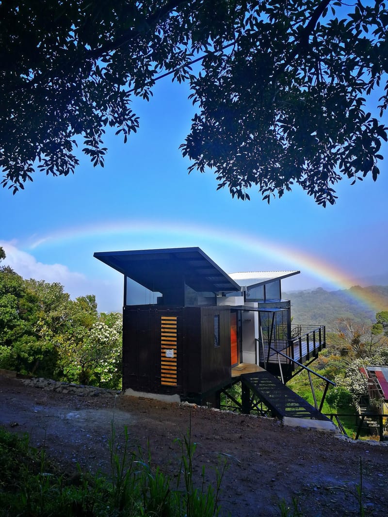 Rainbow over the black container loft seen from the driveway