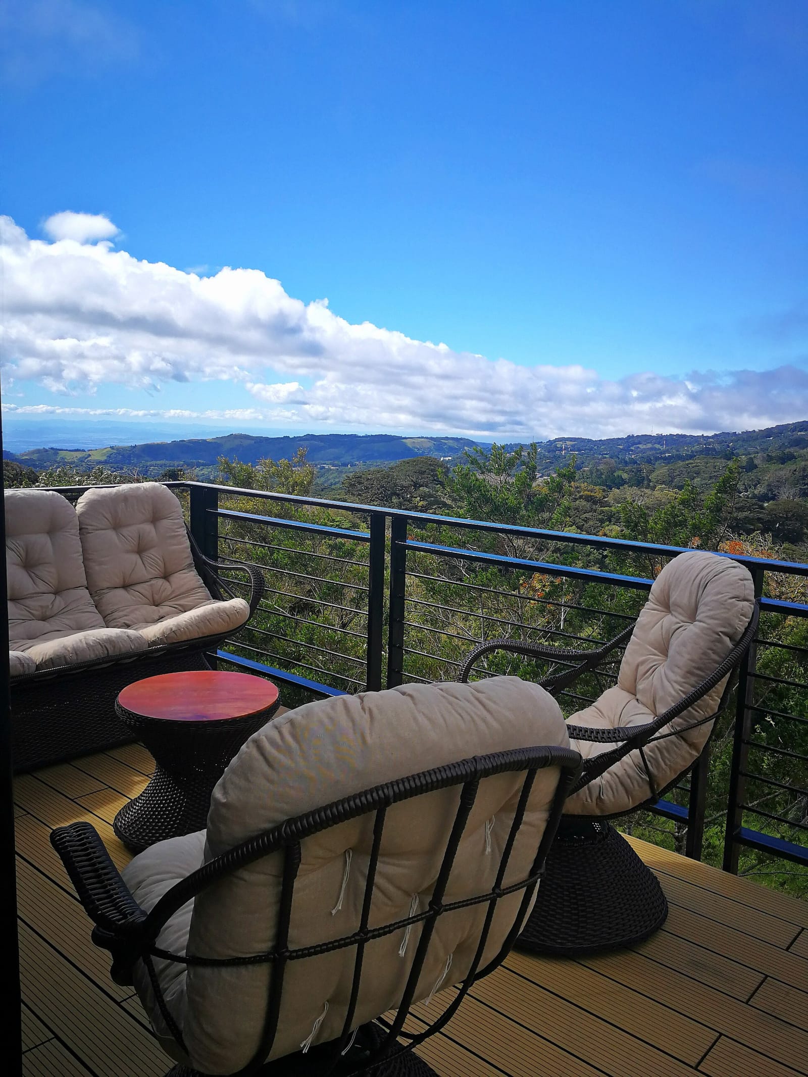 Two swivel chairs on the deck facing the clouded hills