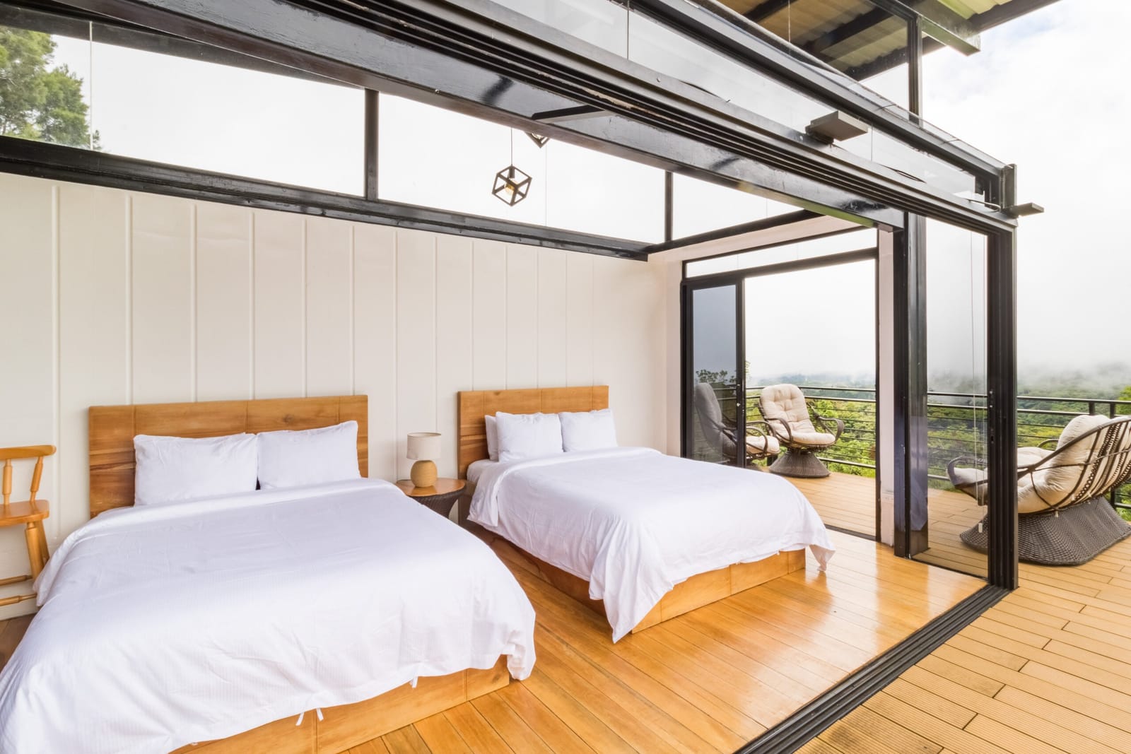 Both beds with wood headboards and the view through the glass
