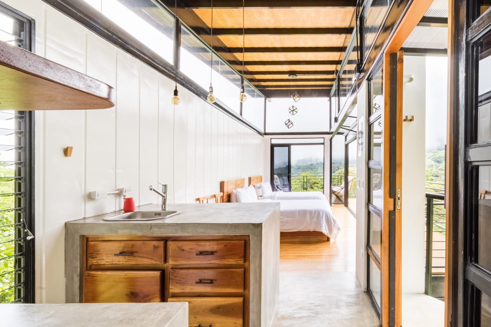 Kitchen sink and drawers with the bedroom behind