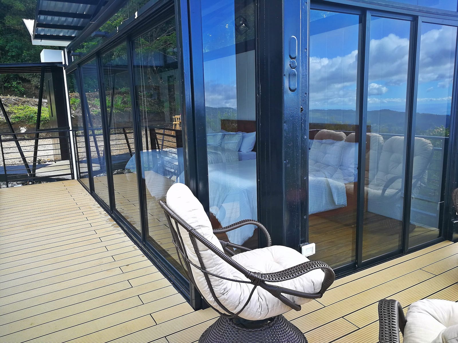 Wooden deck outside the glass doors with a rattan chair