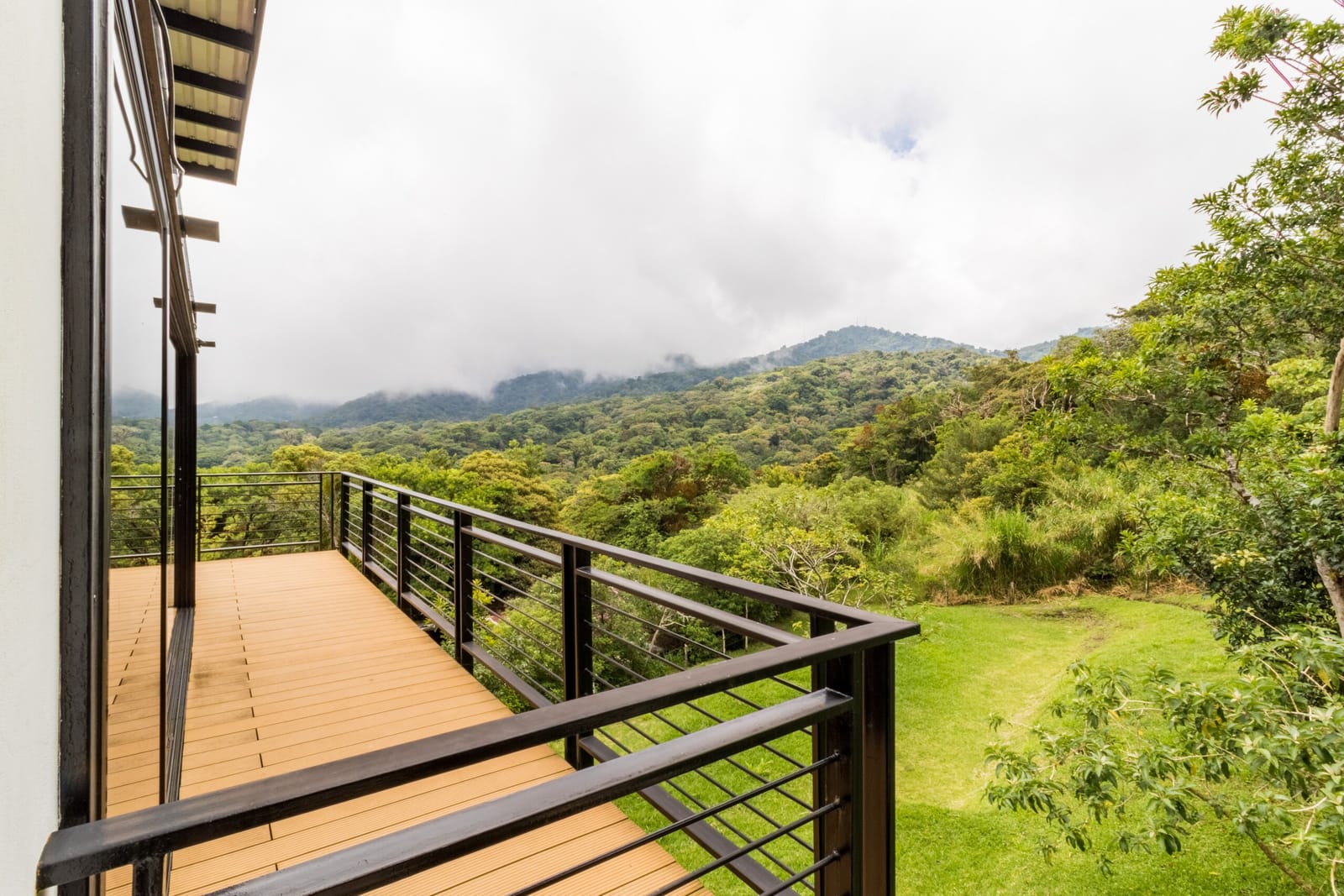 Deck railing looking over the pasture and cloud forest