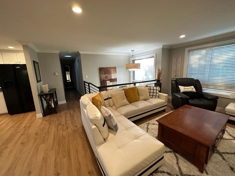 Living room with white sectional sofa and wood coffee table