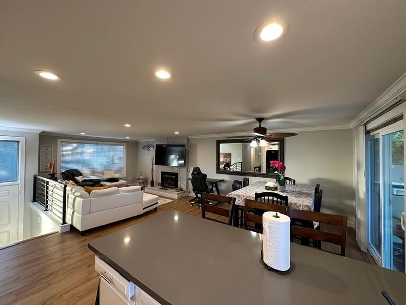 Kitchen peninsula looking into the living room and dining table