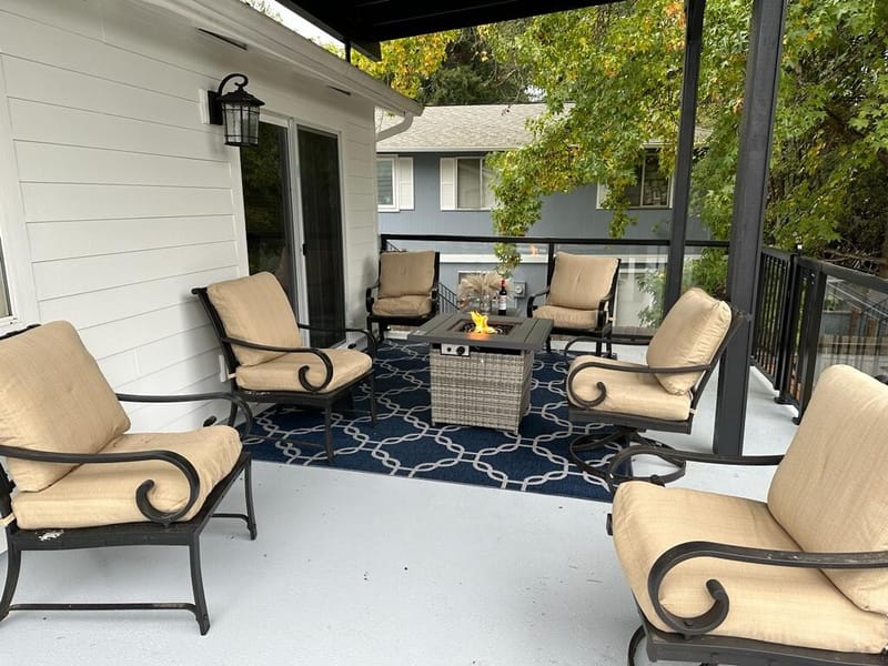 Deck lounge set with cushioned chairs and fire pit