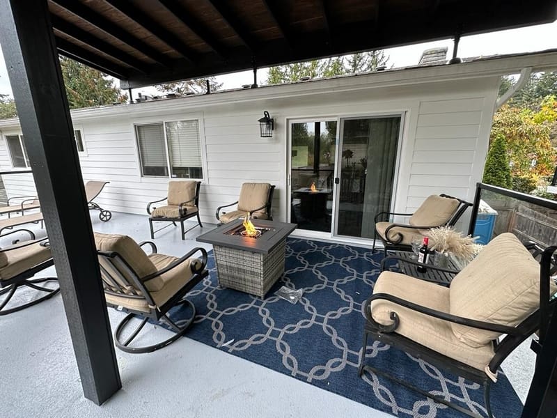 Covered deck with fire pit table and glass doors