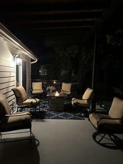 Deck at night with the fire pit lit