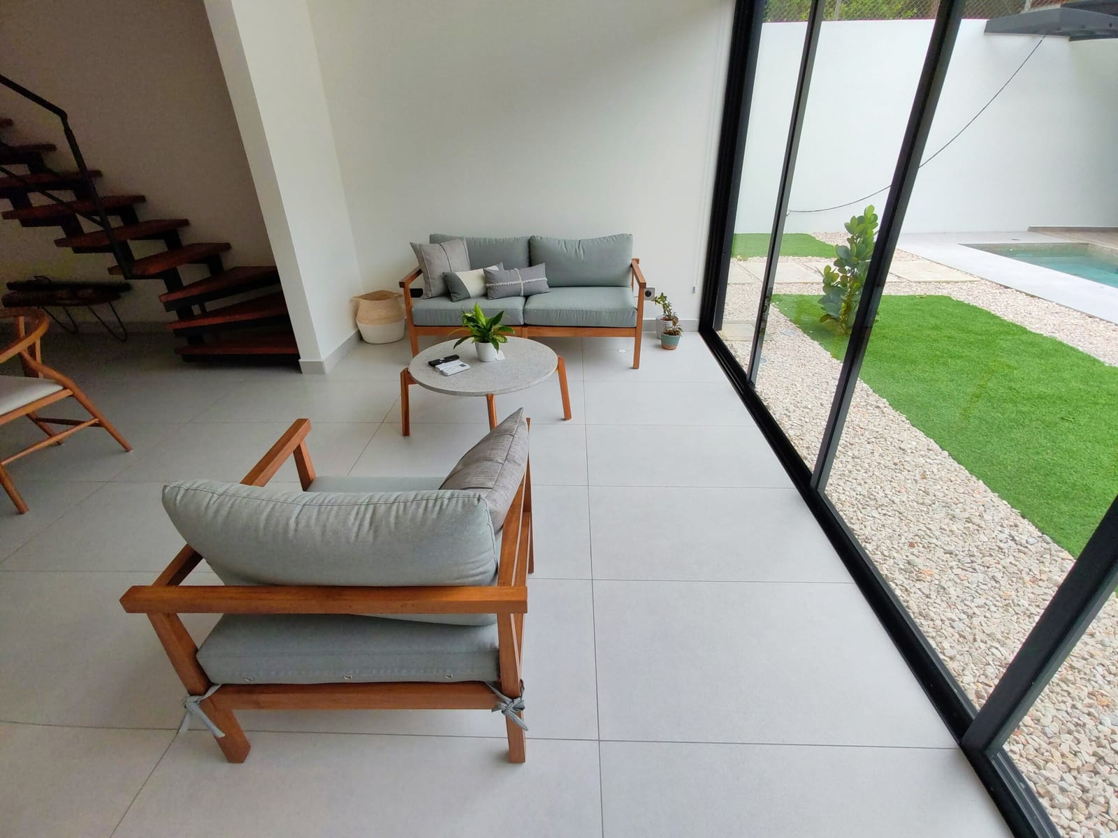 Sitting area with gray sofas and glass doors to the yard