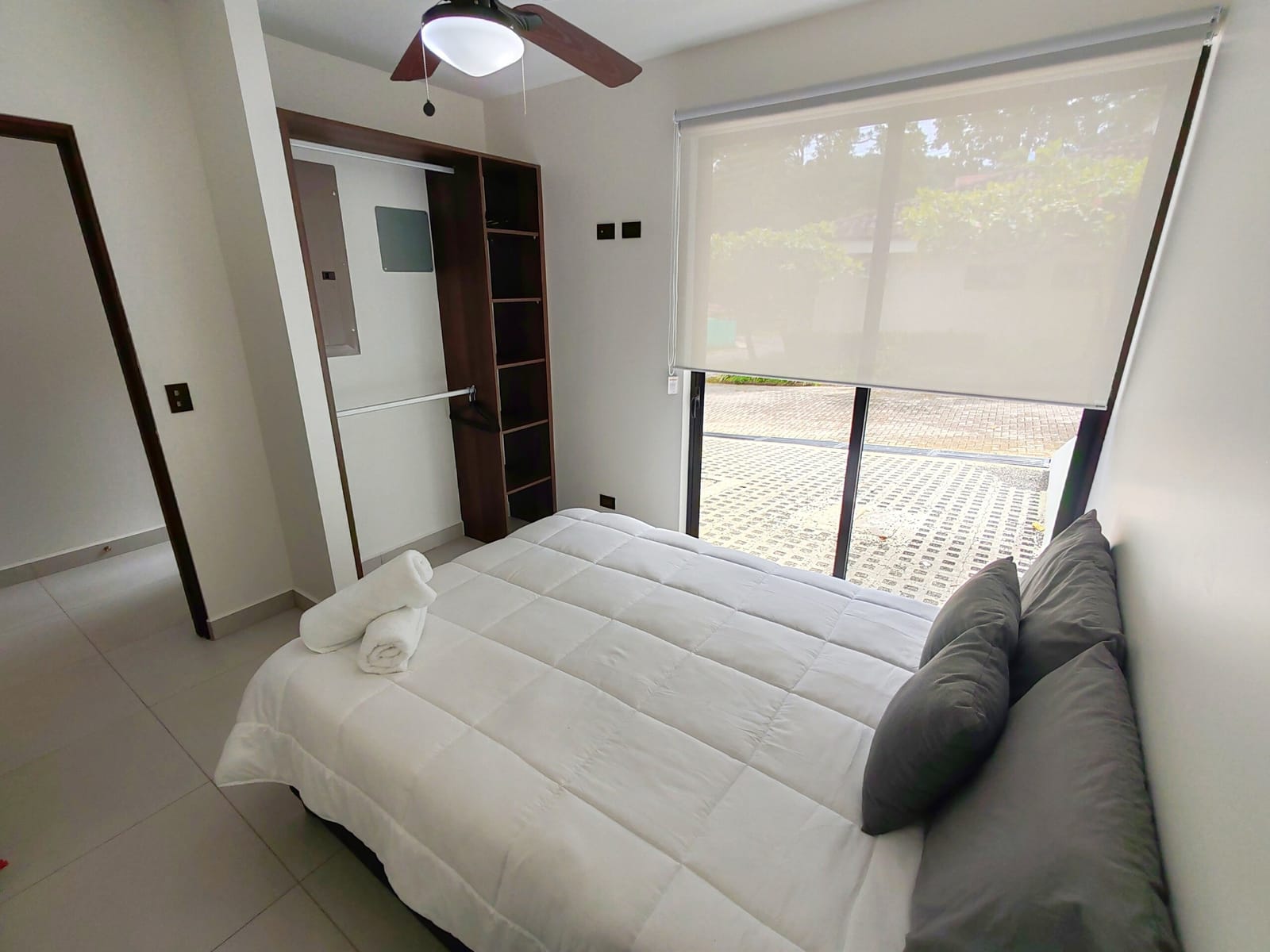 Bedroom with double bed beside a window to the yard