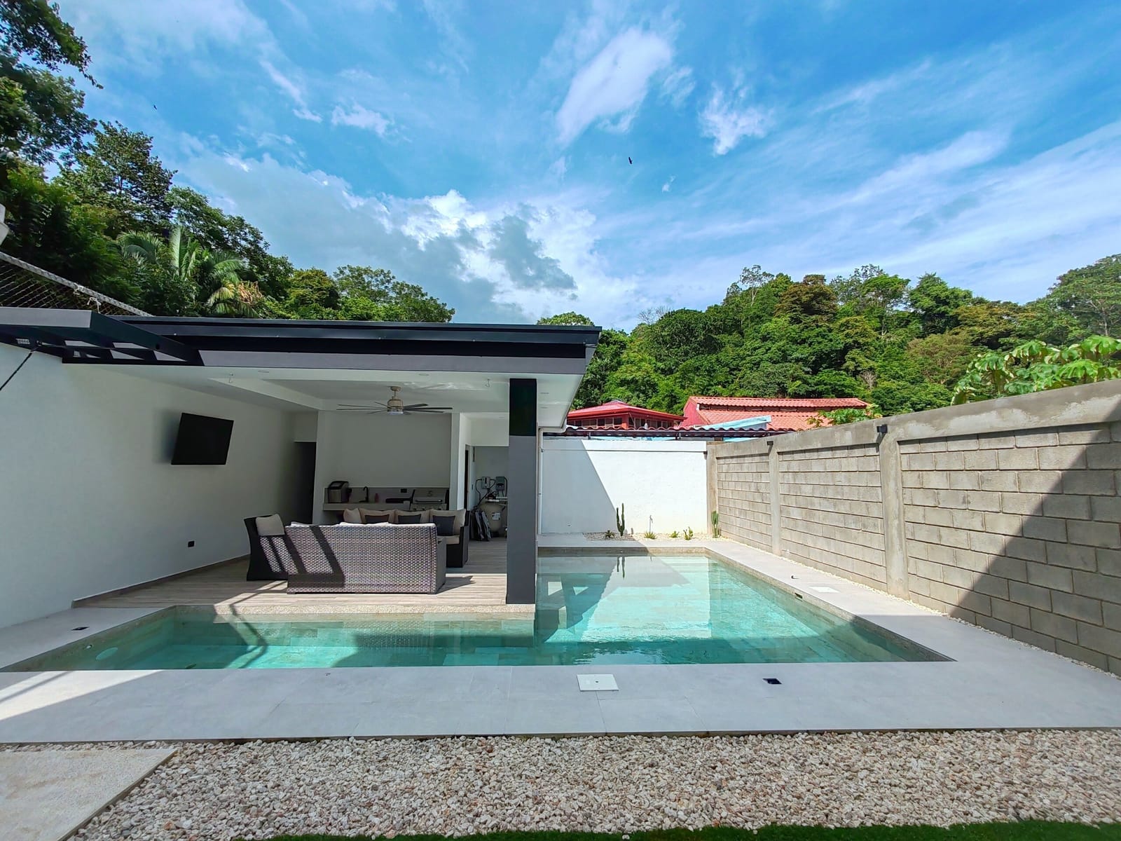 Saltwater pool and covered rancho under a blue sky