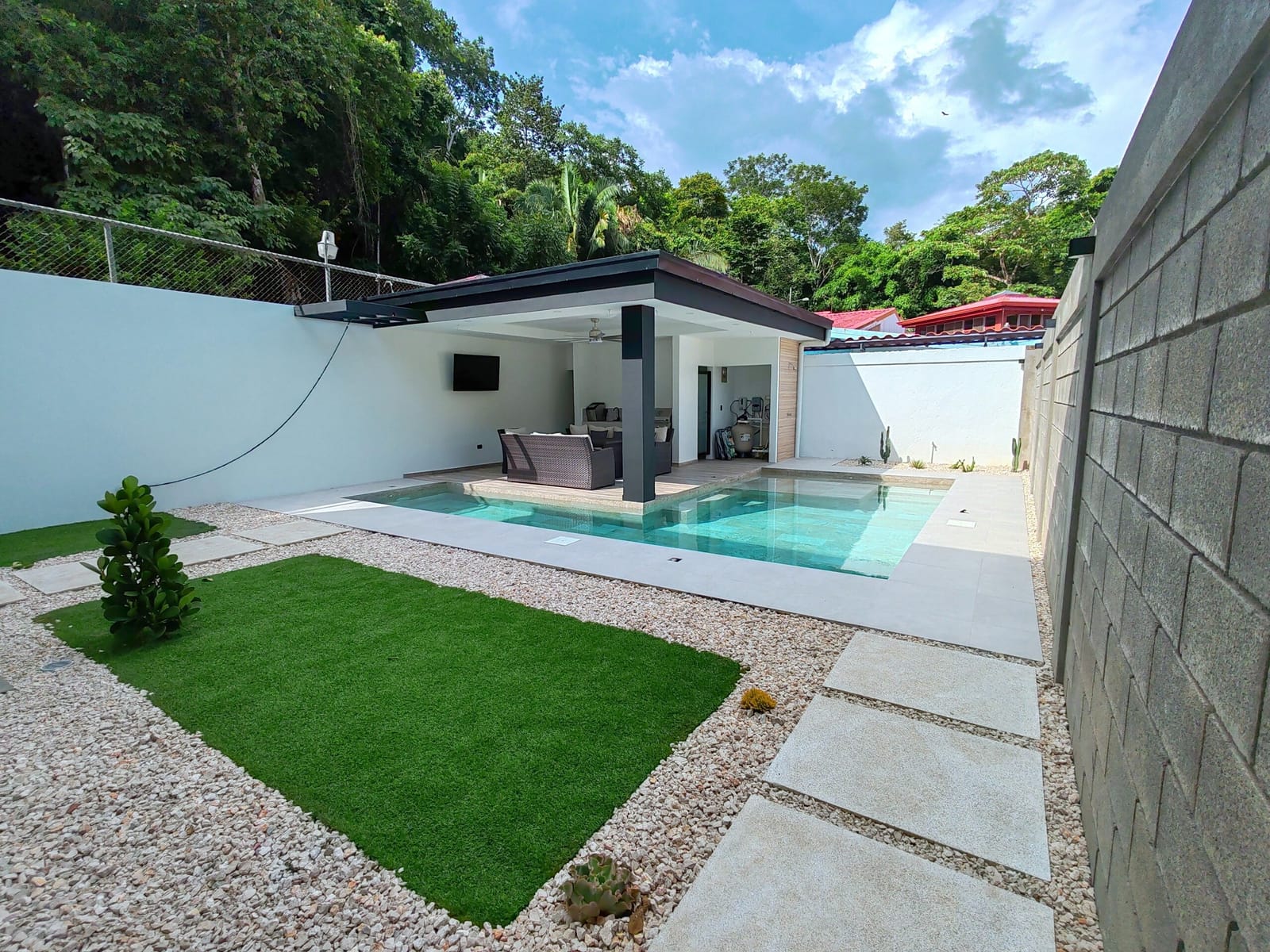 Pool with turf lawn and gravel beside the rancho