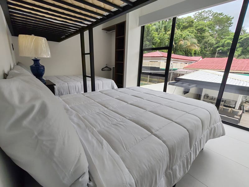 Loft bunk over a double bed with window to the palms