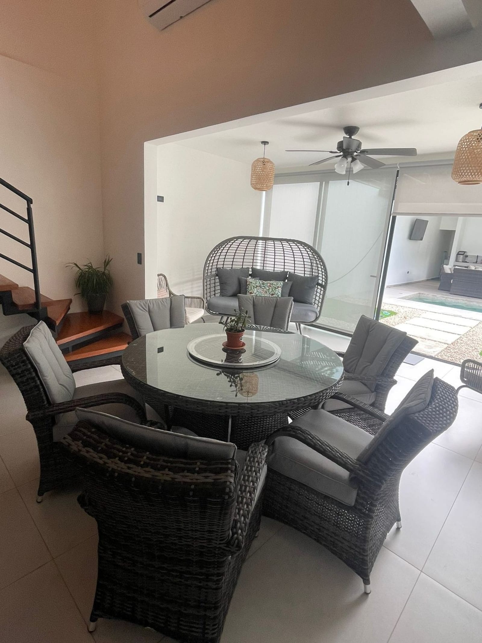 Round rattan dining table by the terrace doors