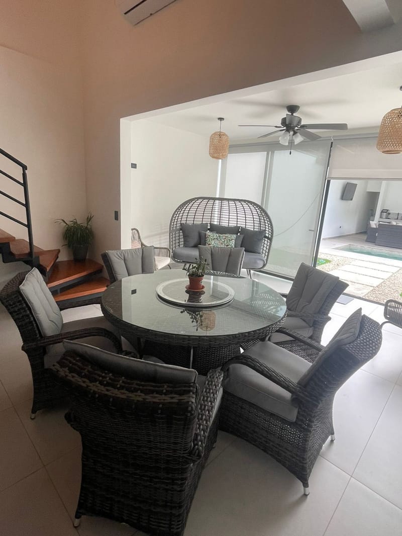 Round rattan dining table by the terrace doors