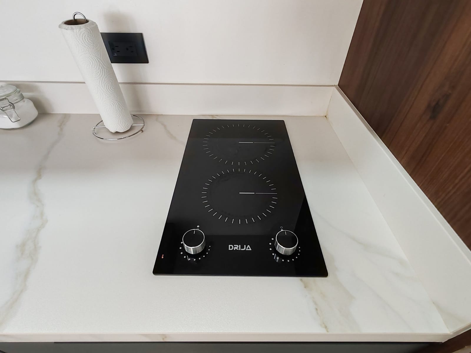 Two-burner electric cooktop set into the marble-look counter
