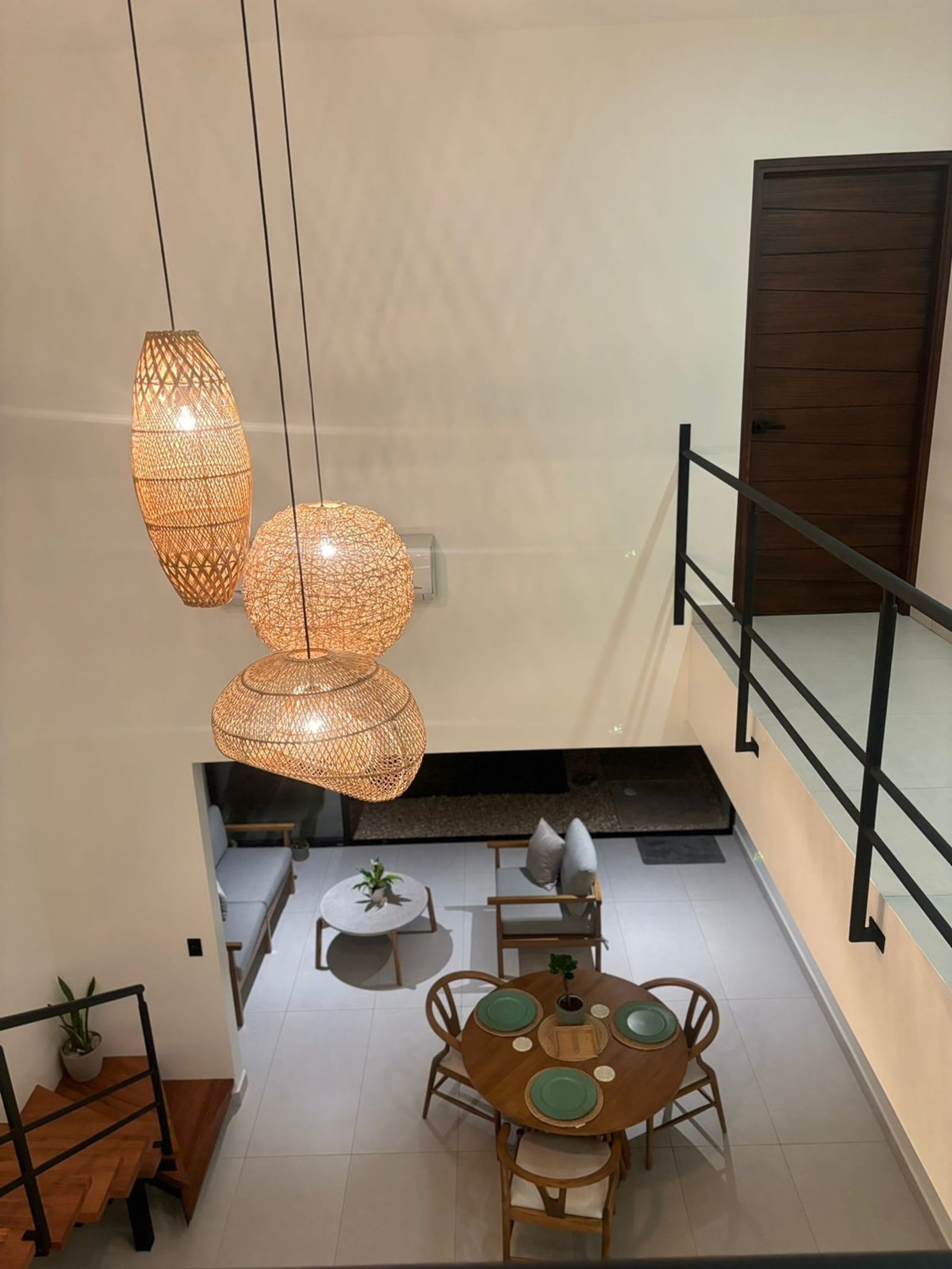 Rattan pendant lamps hanging over the double-height living room