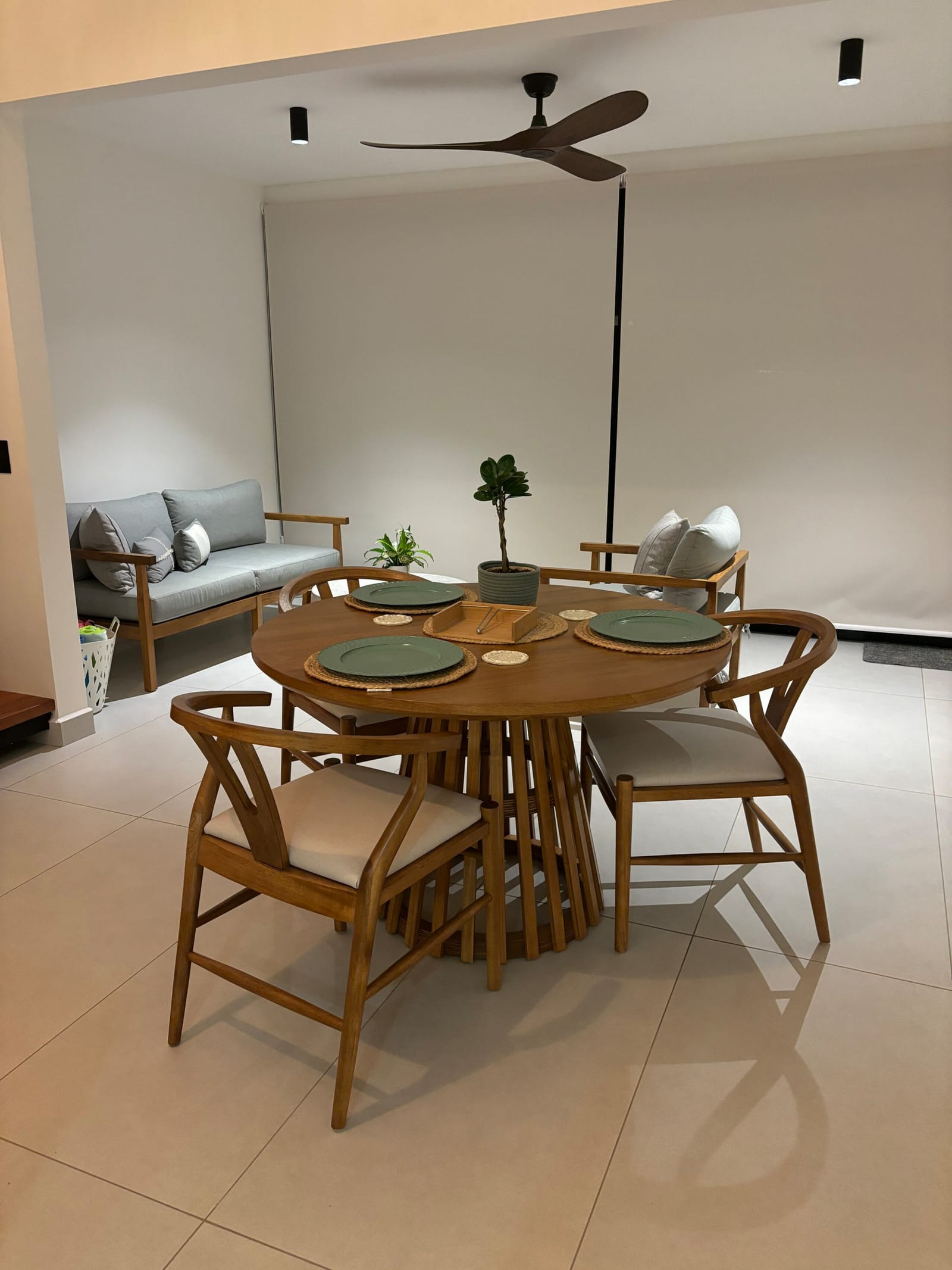 Dining table and gray sofa under the ceiling fan