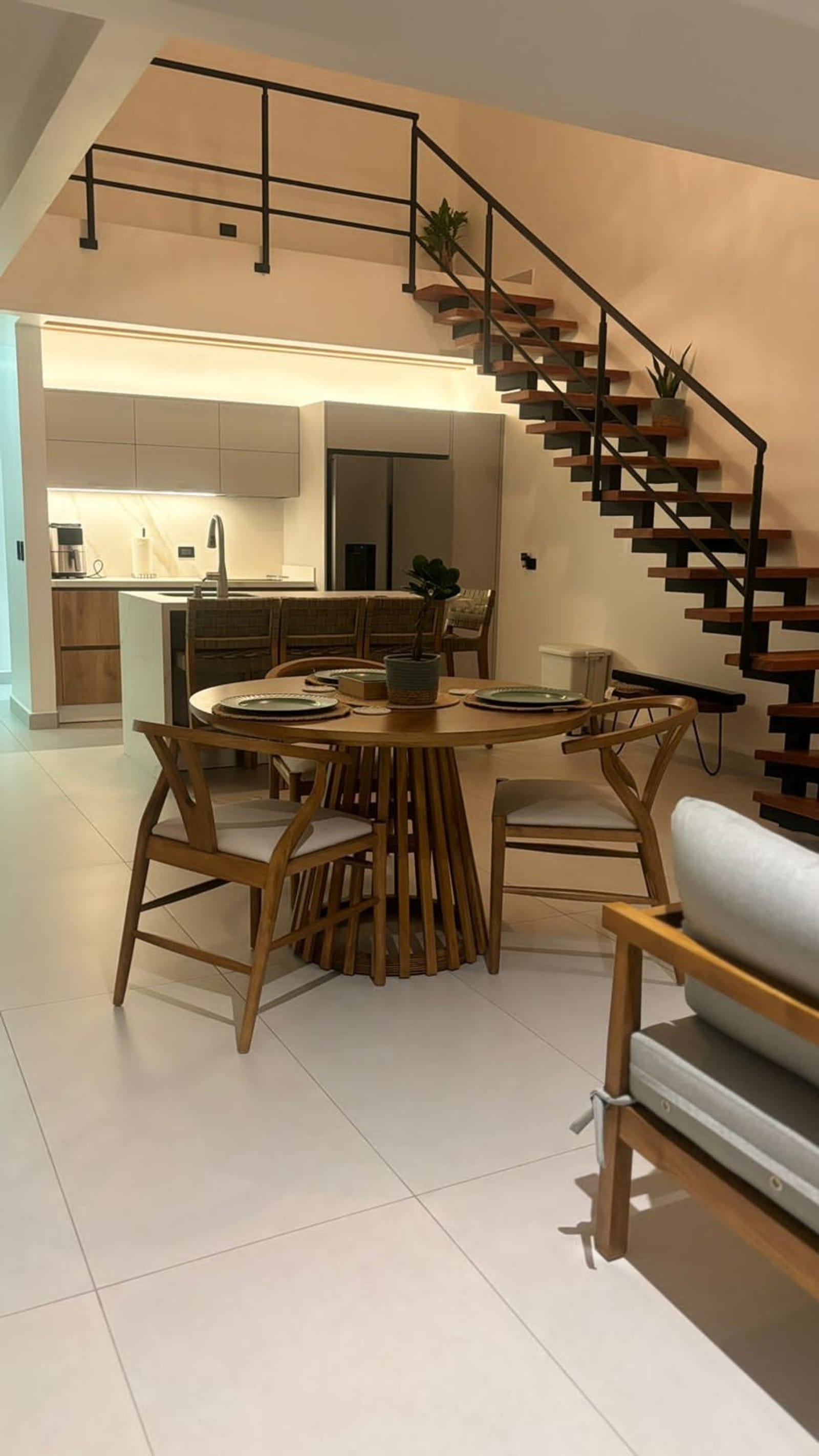 Floating stair beside the dining table and kitchen